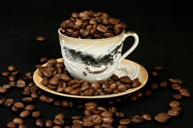 Coffee beans in a cup of oriental style clipart