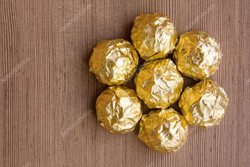 Chocolate sweets in golden foil, Stock image