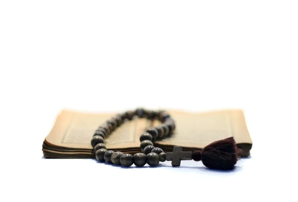 stock image A rosary on antique gospel.