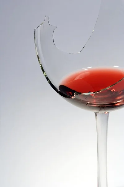 stock image The broken glass with red wine.