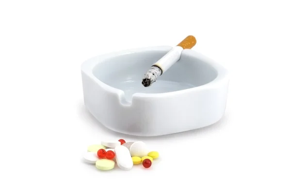Cigarette and medicines. Royalty Free Stock Photos