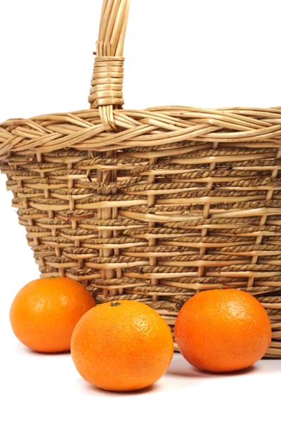 Tangerines and weaved basket. — Stock Photo, Image