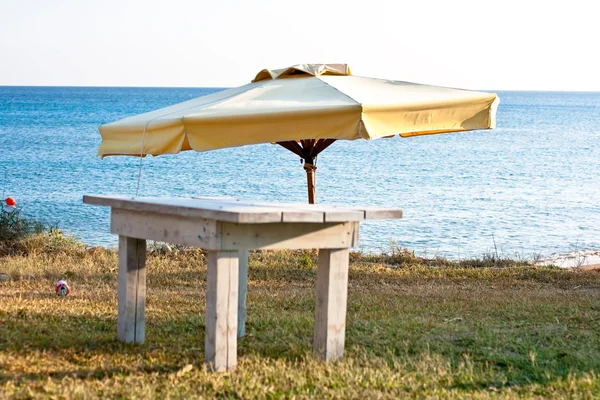 Beach umbrella and table — Stock Photo, Image