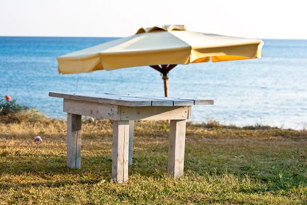 Beach umbrella and table — Stock Photo, Image