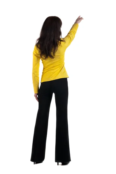 Woman points at wall. The rear view Royalty Free Stock Photos