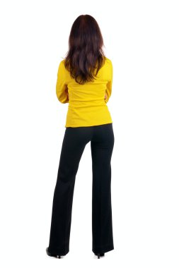 Woman in yellow suit looking at wall. clipart