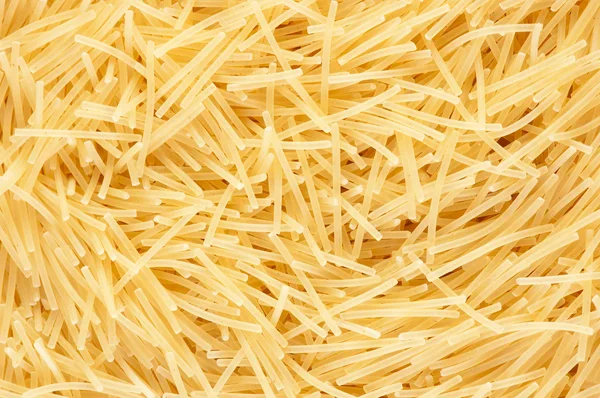 Heap of yellow noodles. As background. — Stock Photo, Image
