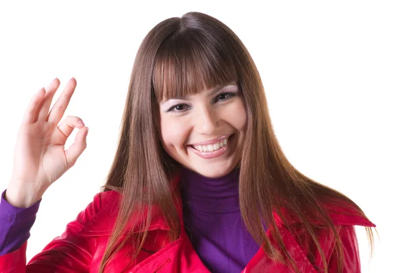 Brunette in red showing ok gesture. — Stock Photo, Image