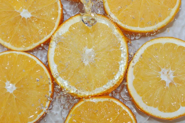 Fresh water drops on oranges — Stock Photo, Image
