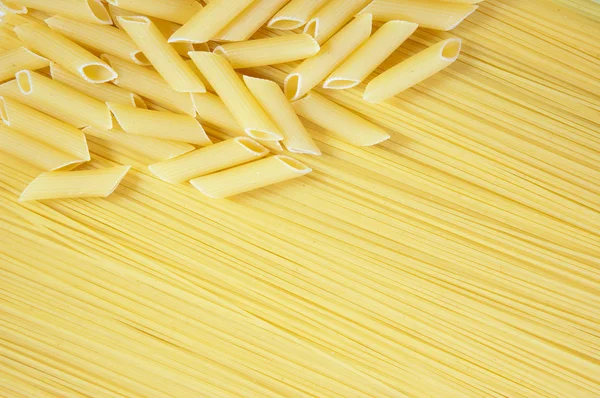 Macaroni on long spaghetti. — Stock Photo, Image