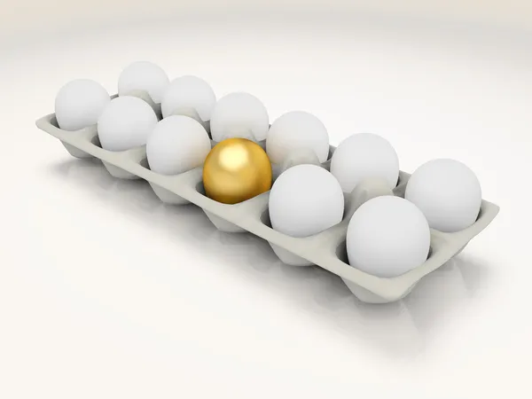 Zlaté vejce v kartonu — Stock fotografie