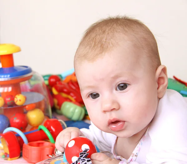 Bebê e montão de brinquedos — Fotografia de Stock