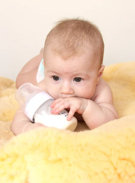 Cute baby with bottle of milk — Stock Photo, Image