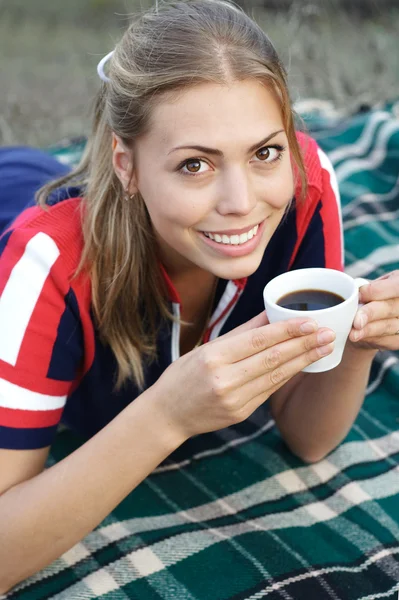 Girl is drinking coffee.