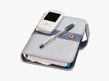 Pen diary and a cell phone clipart