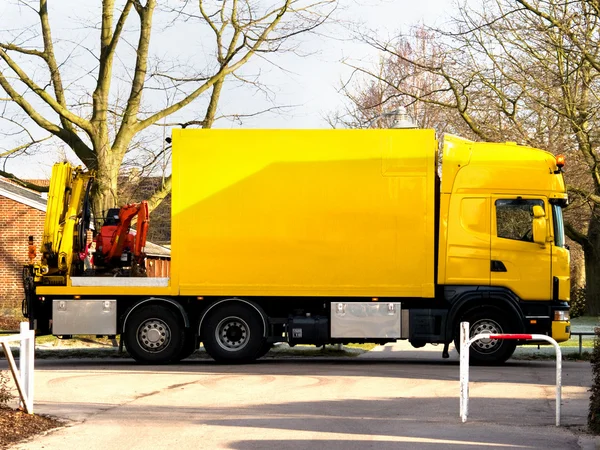 Yellow truck with mini excavator urban — Stock Photo, Image