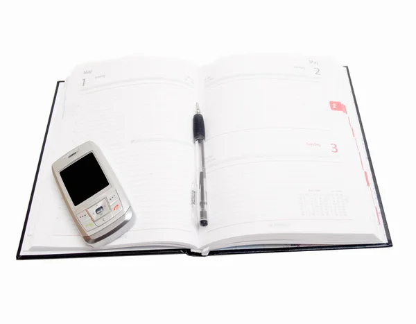 Objekt - dagbok öppen med mobiltelefon på — Stockfoto