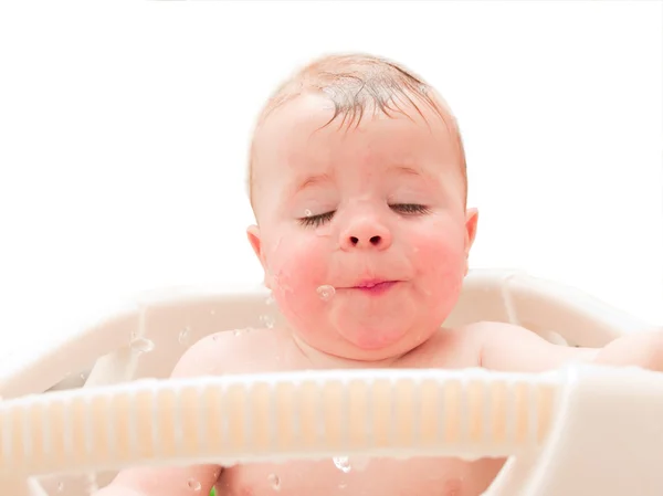 Glücklicher kleiner Junge genießt Wasser in der Badewanne Stockbild