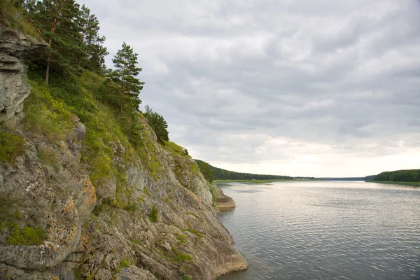 stock image Rocky shore river in cloudy day