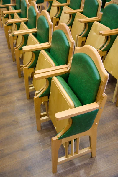 Cadeiras de madeira fileiras em um piso de parquet — Fotografia de Stock