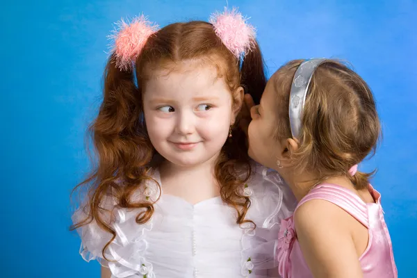 Two little girls talking in whispers — Stock Photo, Image