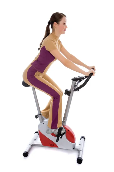 Woman doing fitness on a stationary bike — Stock Photo, Image