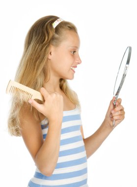 Teen girl look in to mirror and combing clipart