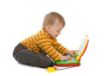 Little boy playing with laptop clipart