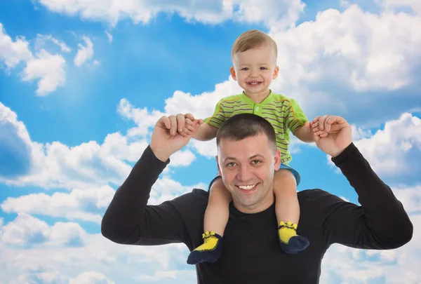 Little son sits on father shoulders — Stock Photo, Image