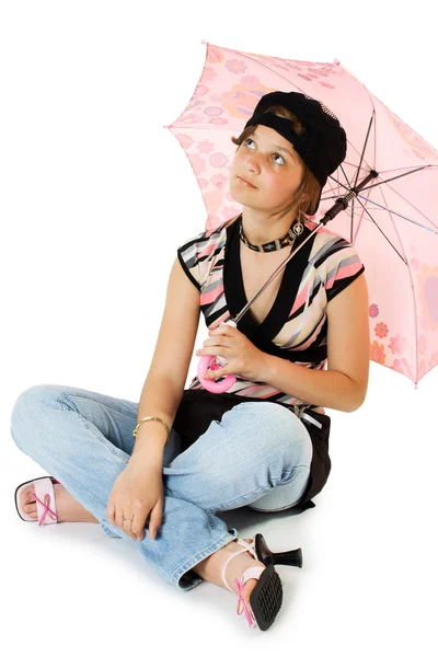 Ung flicka med paraply sitter på golvet Stockbild