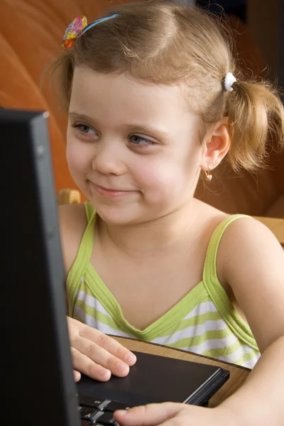 Kleines Mädchen, das mit einem Laptop arbeitet — Stockfoto