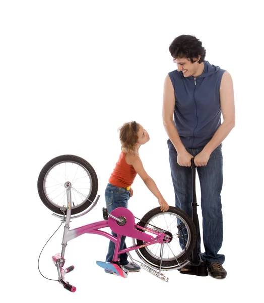 Father and daughter inflate wheel bike — Stock Photo, Image
