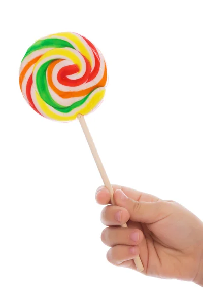 Color lollipop in child hand — Stock Photo, Image