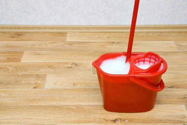 A red mop in a bucket — Stock Photo, Image