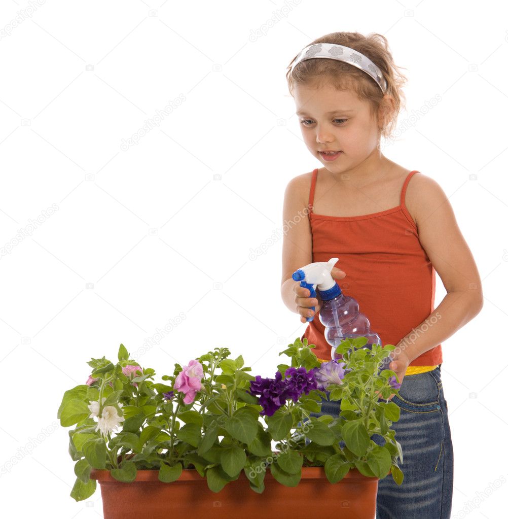 Young girl watering a flower