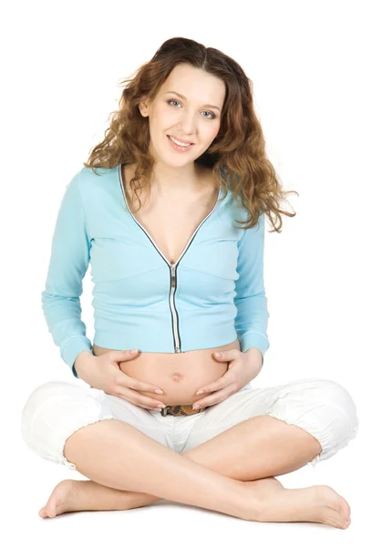 Těhotné ženy, sedící u lotos představují — Stock fotografie