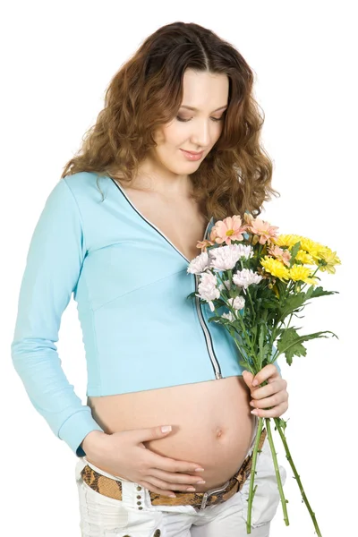 Piękna brunetka w ciąży z kwiatem — Zdjęcie stockowe