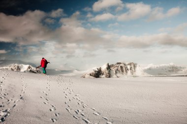 A man climbs on a snow slope clipart