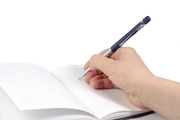 Notebook z ręka trzymająca długopis — Zdjęcie stockowe