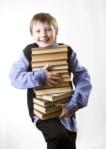 Bir kitap yığını ile çocuk — Stok fotoğraf
