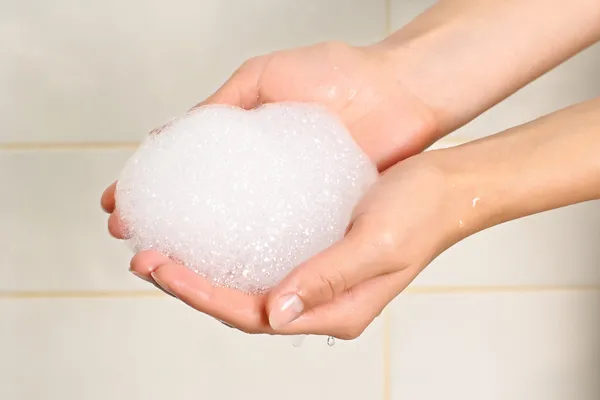 Soap suds in palms — Stock Photo, Image