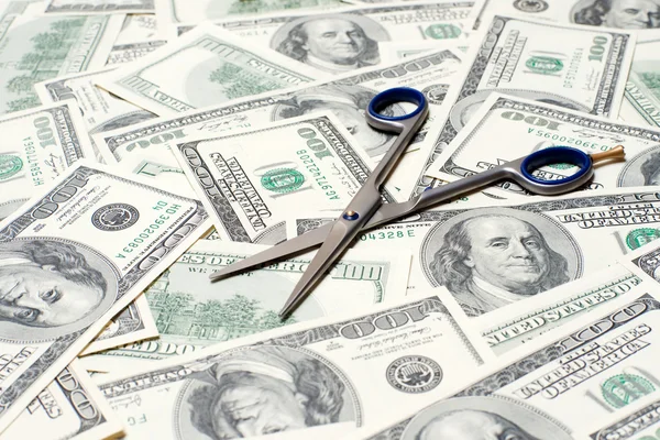 Scissors on the dollar background — Stock Photo, Image