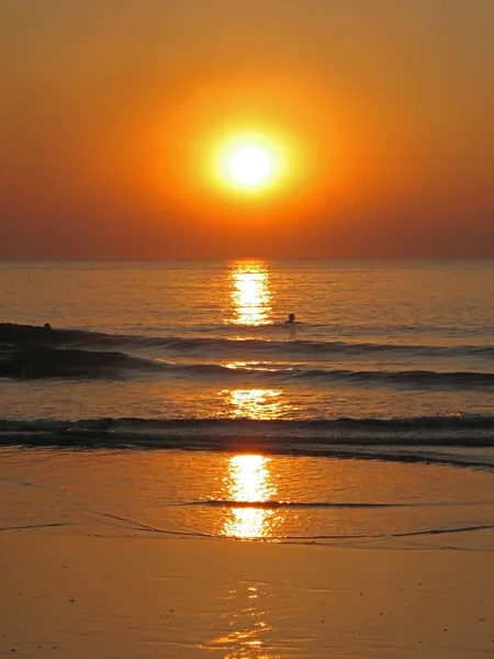 Homme nager au coucher du soleil — Photo