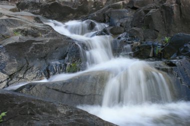 Water flowing over rocks clipart