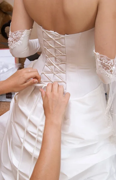 Hands tightening a corset bride — Stock Photo, Image
