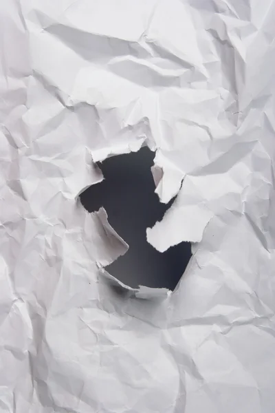 Hole in a crushed paper. — Stock Photo, Image