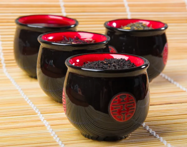 stock image Porcelain cups for tea on bamboo straws