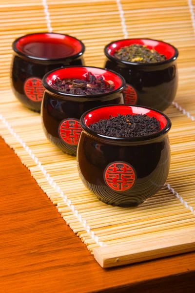 stock image Porcelain cups for tea on bamboo straws