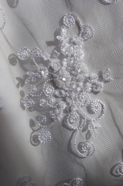Embroidery on a white thin fabric beads — Stock Photo, Image
