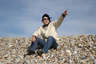 Young Man Gestures at the beach clipart